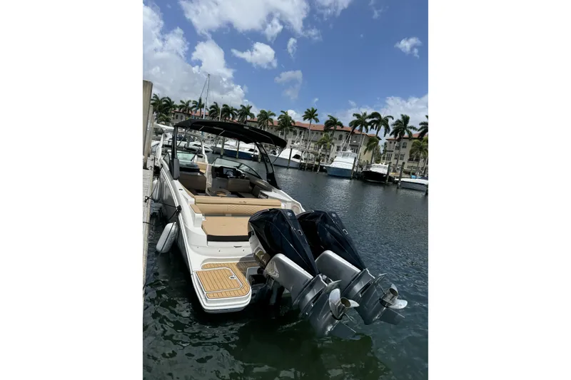 Slide: The Image of 2024 Sea Ray SDX 290 Outboard docked, featuring dual engines and luxurious seating. - 1