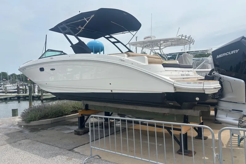 Slide: The Image of 2024 Sea Ray SDX 290 Outboard boat on display at a marina. - 12