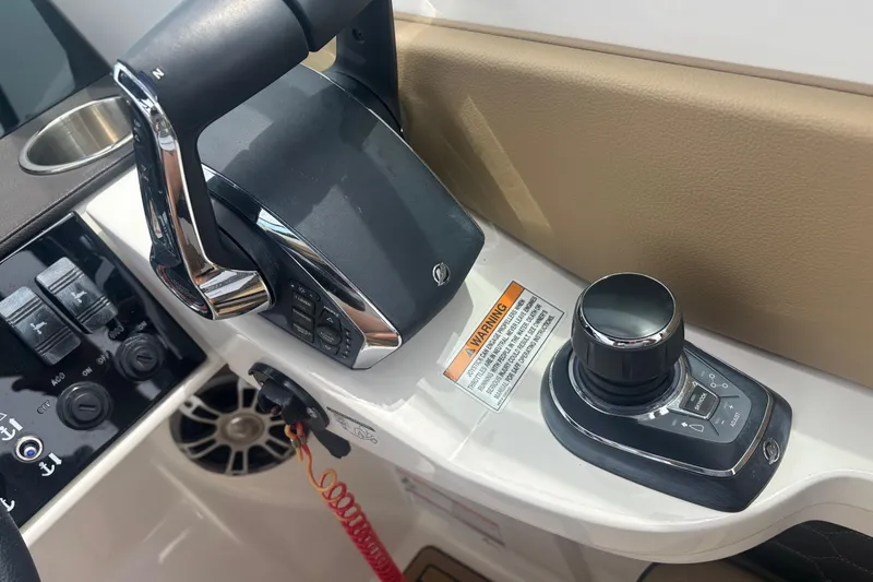 Slide: The Image of 2024 Sea Ray SDX 290 Outboard control panel with joystick and throttle. - 18