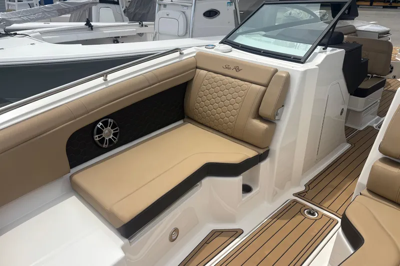 Slide: The Image of 2024 Sea Ray SDX 290 Outboard boat interior with tan seating and sleek design. - 20