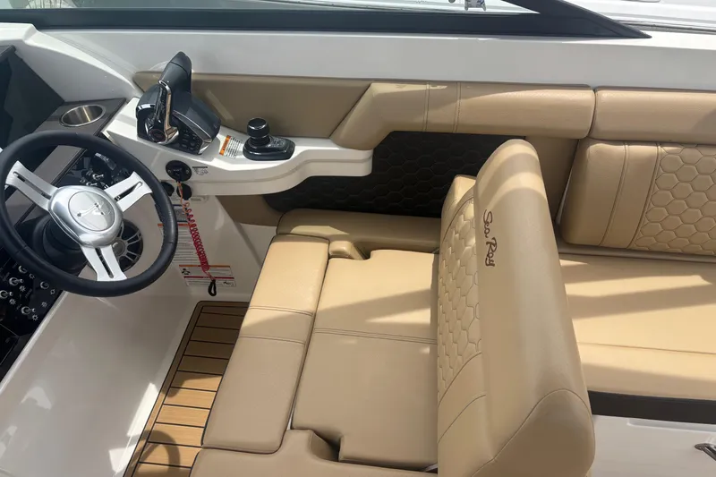 Slide: The Image of 2024 Sea Ray SDX 290 Outboard cockpit with beige seating and modern controls. - 21