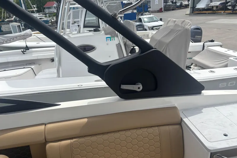 Slide: The Image of 2024 Sea Ray SDX 290 Outboard interior with beige seating and sleek design elements. - 22