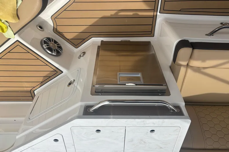 Slide: The Image of 2024 Sea Ray SDX 290 Outboard interior with seating, speaker, and storage compartments. - 23
