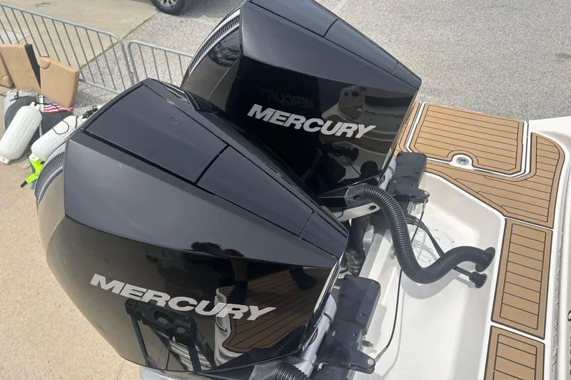 Slide: The Image of Twin Mercury outboard engines on a 2024 Sea Ray SDX 290 boat. - 25