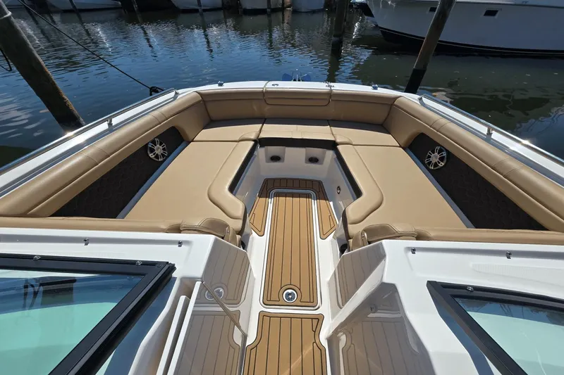 Slide: The Image of 2024 Sea Ray SDX 290 Outboard boat interior with tan seating and wood accents. - 6