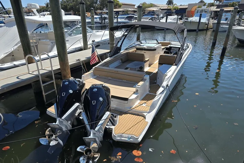 Slide: The Image of 2024 Sea Ray SDX 290 Outboard boat docked in marina, featuring dual engines. - 9