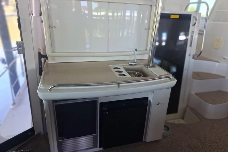 Slide: The Image of 1997 Carver 500 Cockpit Motor Yacht interior with kitchenette and stairs. - 10