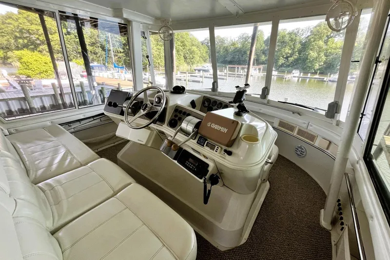 Slide: The Image of Interior of 1997 Carver 500 Cockpit Motor Yacht with helm and seating area. - 11