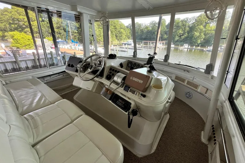 Slide: The Image of Interior of 1997 Carver 500 Cockpit Motor Yacht with helm and seating area. - 12