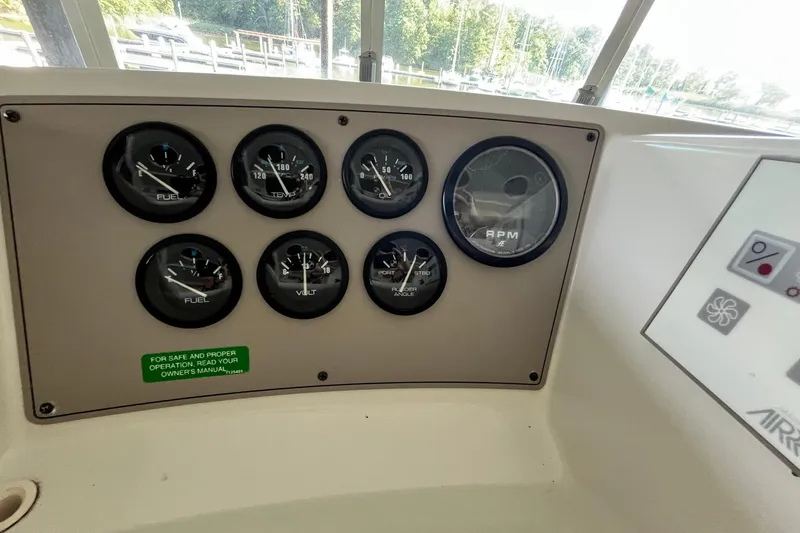 Slide: The Image of Instrument panel of a 1997 Carver 500 Cockpit Motor Yacht with gauges and controls. - 18