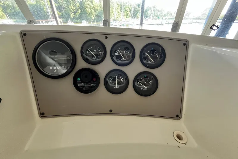 Slide: The Image of Instrument panel of a 1997 Carver 500 Cockpit Motor Yacht with gauges and RPM dial. - 19