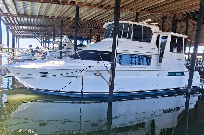 Slide: The Image of 1997 Carver 500 Cockpit Motor Yacht docked in a covered marina. - 2