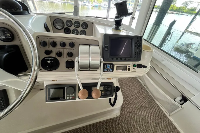 Slide: The Image of 1997 Carver 500 Cockpit Motor Yacht helm with navigation controls and gauges. - 21