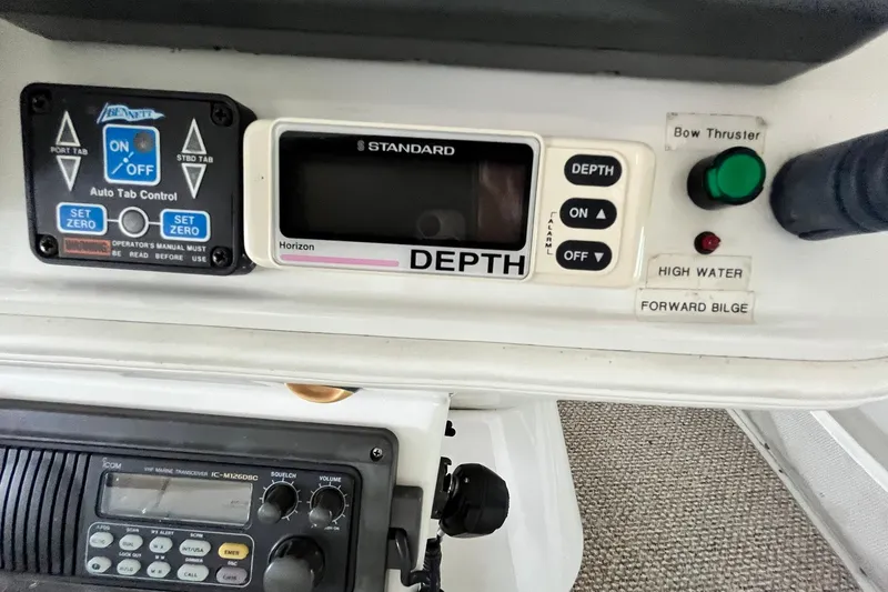 Slide: The Image of Control panel of a 1997 Carver 500 Cockpit Motor Yacht with depth gauge and switches. - 23