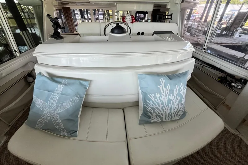 Slide: The Image of Interior of 1997 Carver 500 Cockpit Motor Yacht with decorative marine-themed pillows. - 24