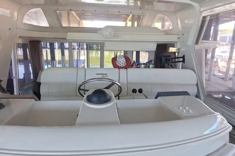 Slide: The Image of Interior view of 1997 Carver 500 Cockpit Motor Yacht helm with steering wheel and controls. - 27