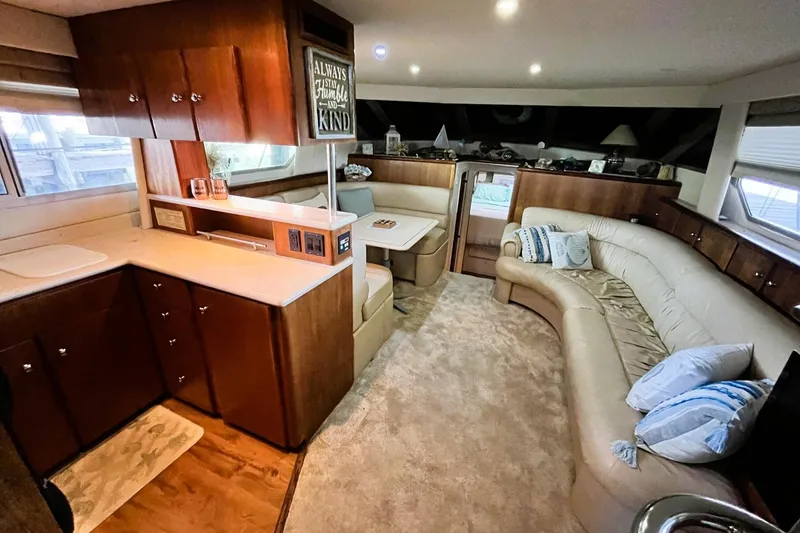Slide: The Image of Interior of 1997 Carver 500 Cockpit Motor Yacht with cozy seating and wooden cabinetry. - 28