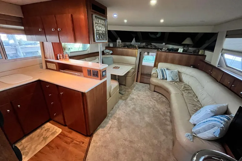 Slide: The Image of Luxurious interior of a 1997 Carver 500 Cockpit Motor Yacht with plush seating and wood cabinetry. - 29