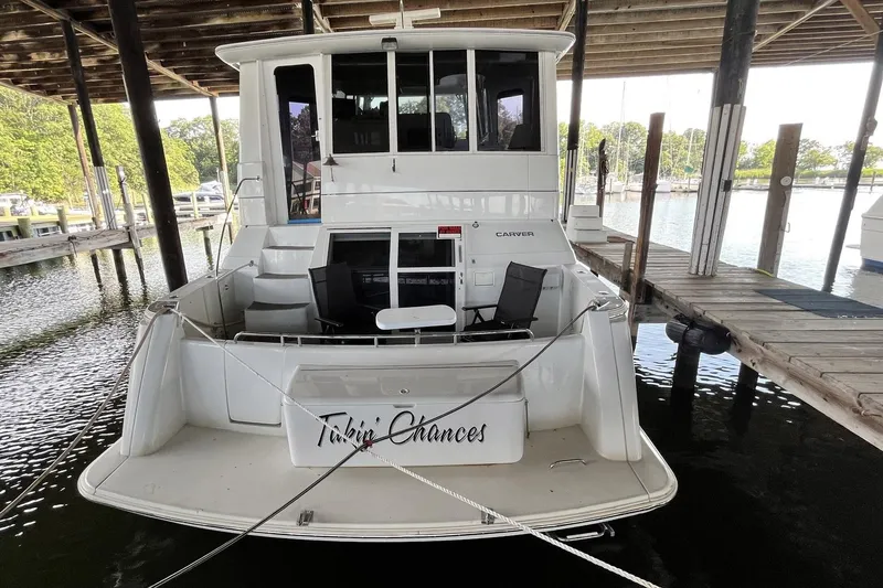 Slide: The Image of 1997 Carver 500 Cockpit Motor Yacht docked under a covered marina. - 3