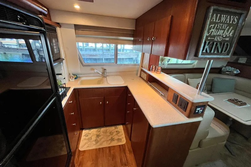 Slide: The Image of Interior of 1997 Carver 500 Cockpit Motor Yacht with modern kitchen and cozy seating area. - 31