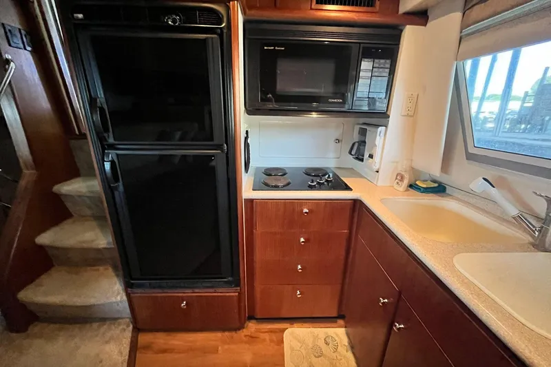 Slide: The Image of Interior kitchen of 1997 Carver 500 Cockpit Motor Yacht with appliances and sink. - 33