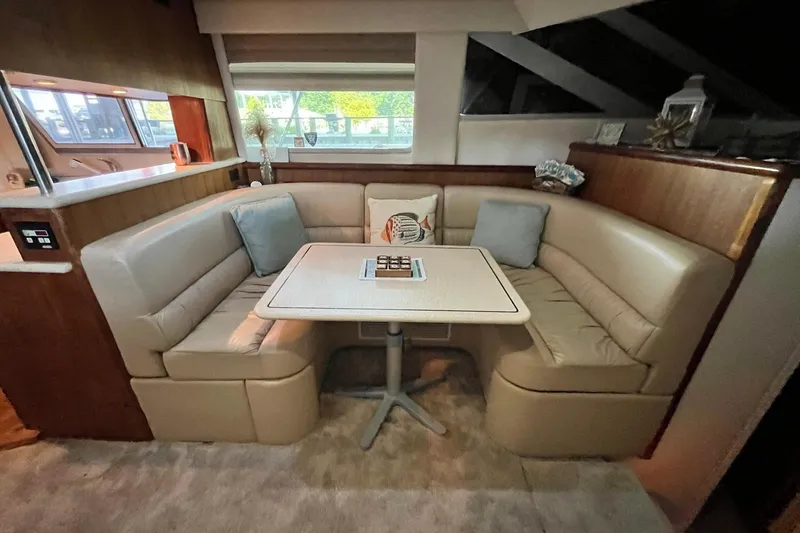 Slide: The Image of Luxurious 1997 Carver 500 Cockpit Motor Yacht interior with cozy dining area and plush seating. - 35