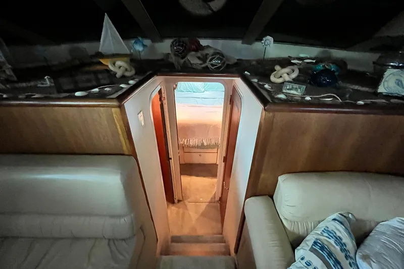 Slide: The Image of Interior of 1997 Carver 500 Cockpit Motor Yacht, featuring cozy cabin and nautical decor. - 37