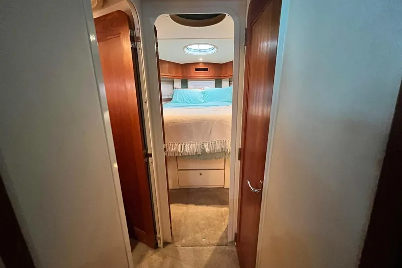 Slide: The Image of Interior view of a 1997 Carver 500 Cockpit Motor Yacht bedroom with cozy bedding. - 39
