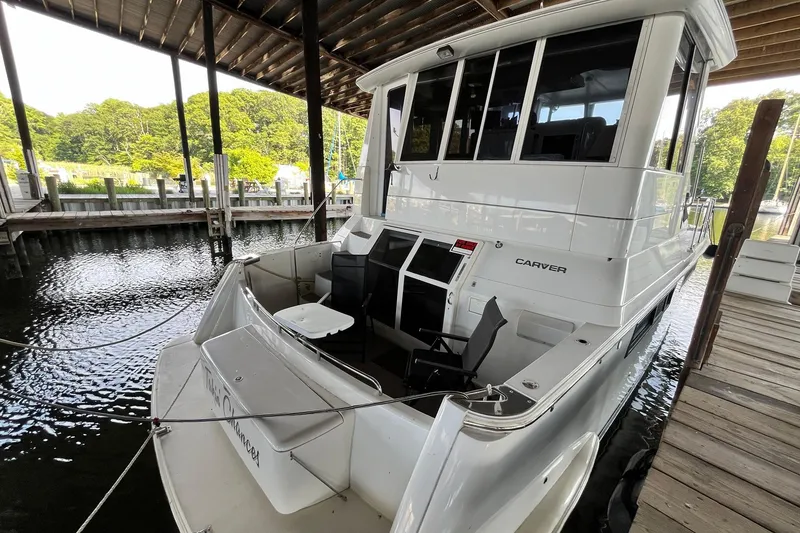 Slide: The Image of 1997 Carver 500 Cockpit Motor Yacht docked under a covered marina. - 4