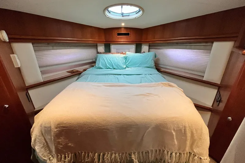 Slide: The Image of Luxurious bedroom interior of 1997 Carver 500 Cockpit Motor Yacht with cozy bedding. - 40