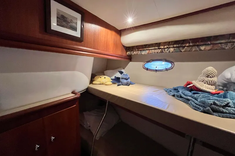 Slide: The Image of Cozy cabin interior of 1997 Carver 500 Cockpit Motor Yacht with plush toys and bedding. - 44