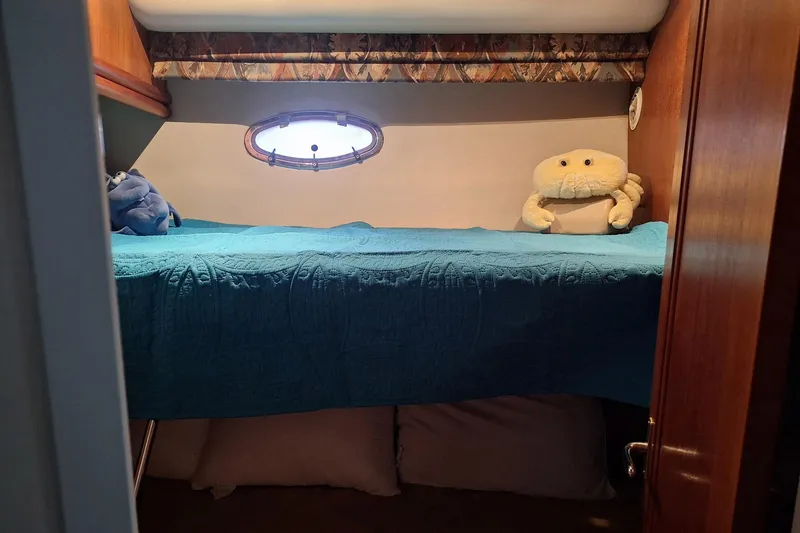 Slide: The Image of Cozy cabin interior of 1997 Carver 500 Cockpit Motor Yacht with plush toys and porthole. - 45