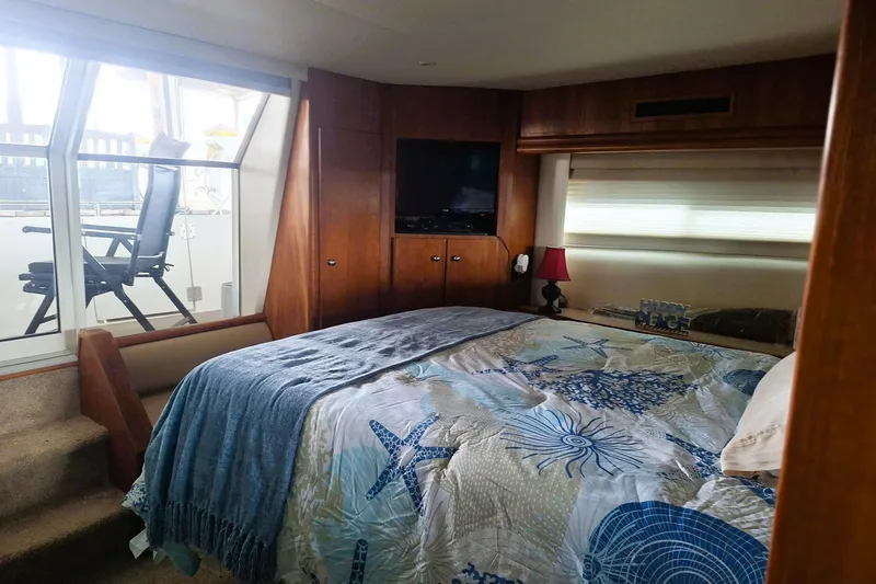 Slide: The Image of Cozy bedroom in 1997 Carver 500 Cockpit Motor Yacht with nautical decor. - 49