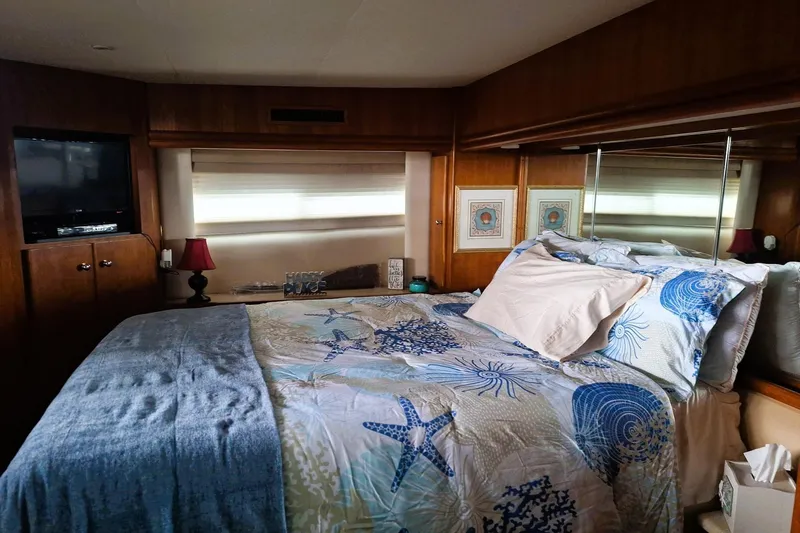 Slide: The Image of Cozy bedroom in 1997 Carver 500 Cockpit Motor Yacht with nautical-themed bedding. - 50