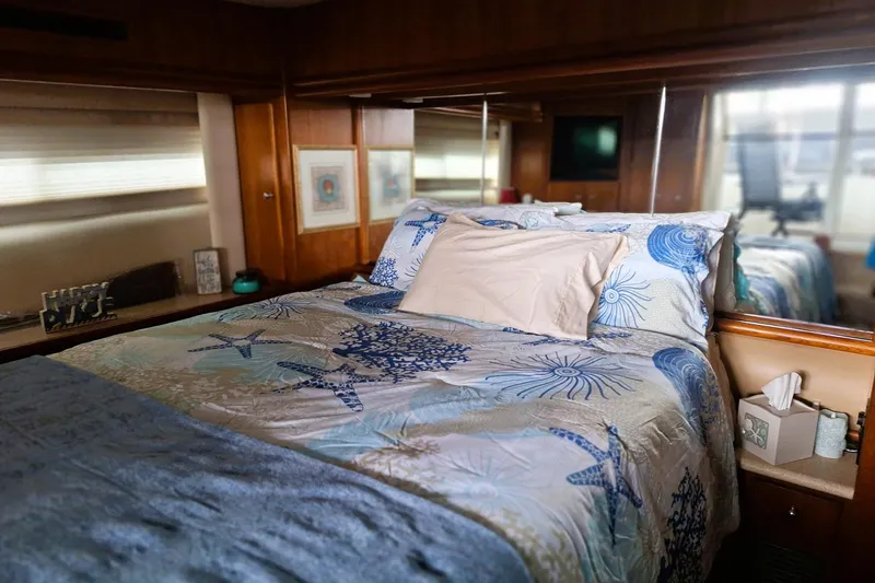 Slide: The Image of Cozy bedroom in 1997 Carver 500 Cockpit Motor Yacht with nautical-themed bedding. - 51