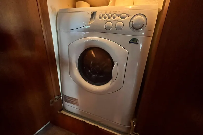 Slide: The Image of Washing machine inside 1997 Carver 500 Cockpit Motor Yacht's wooden cabinet. - 56