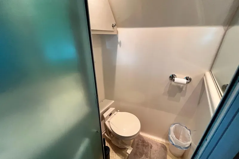Slide: The Image of Bathroom interior of 1997 Carver 500 Cockpit Motor Yacht with toilet and trash bin. - 57