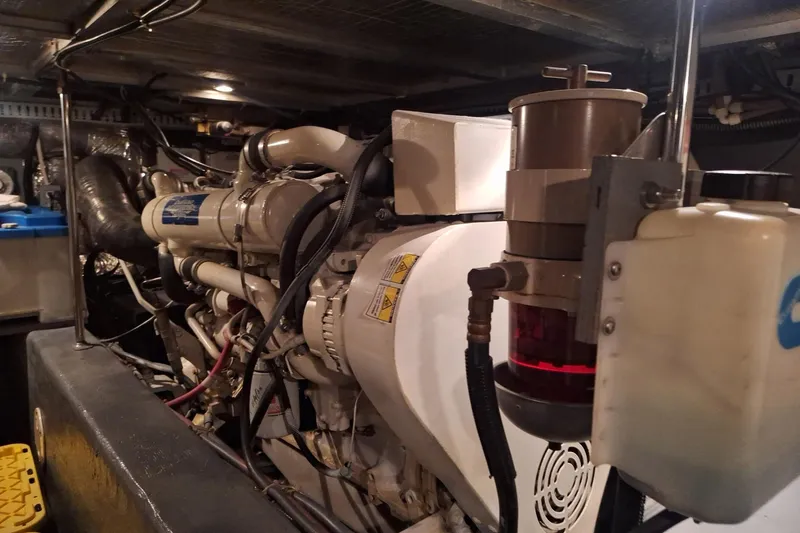 Slide: The Image of Engine room of a 1997 Carver 500 Cockpit Motor Yacht, showcasing mechanical components. - 59