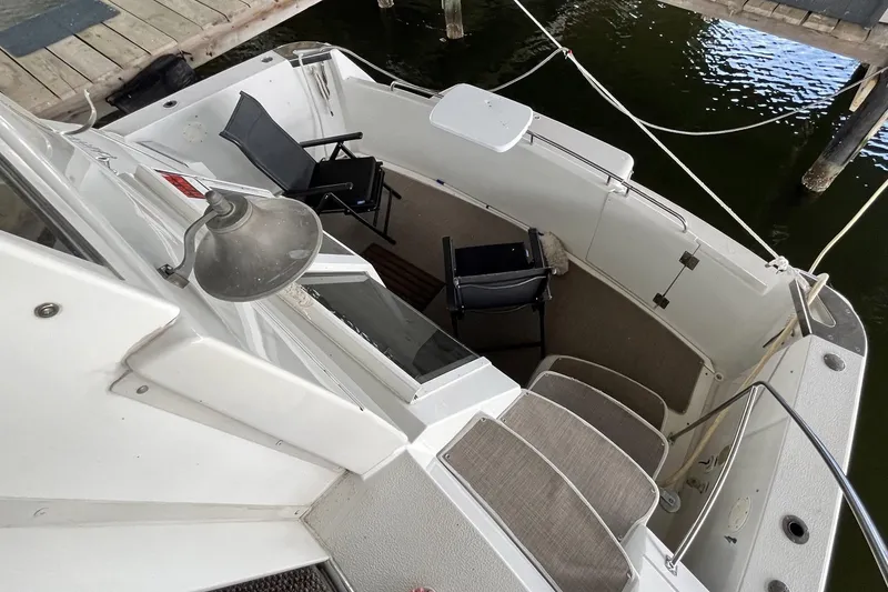 Slide: The Image of 1997 Carver 500 Cockpit Motor Yacht with seating area and dock view. - 6