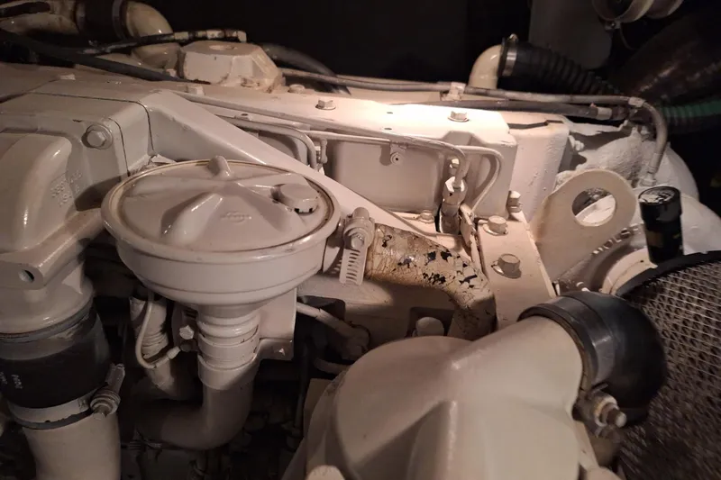 Slide: The Image of Engine compartment of a 1997 Carver 500 Cockpit Motor Yacht, showing mechanical components. - 60