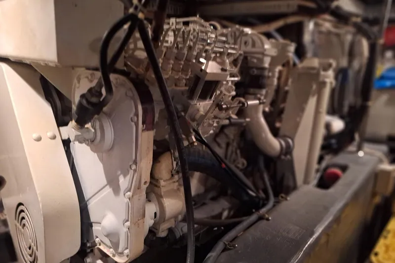 Slide: The Image of Engine compartment of a 1997 Carver 500 Cockpit Motor Yacht, showcasing mechanical components. - 61
