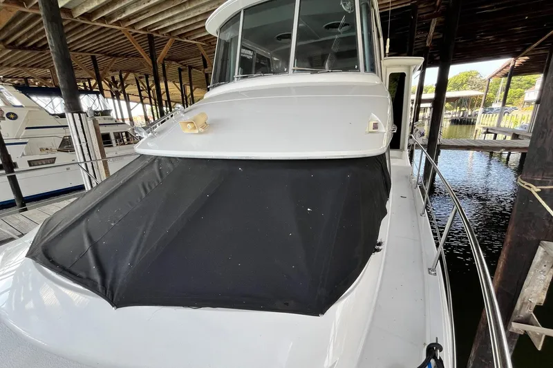 Slide: The Image of 1997 Carver 500 Cockpit Motor Yacht docked under covered marina. - 69