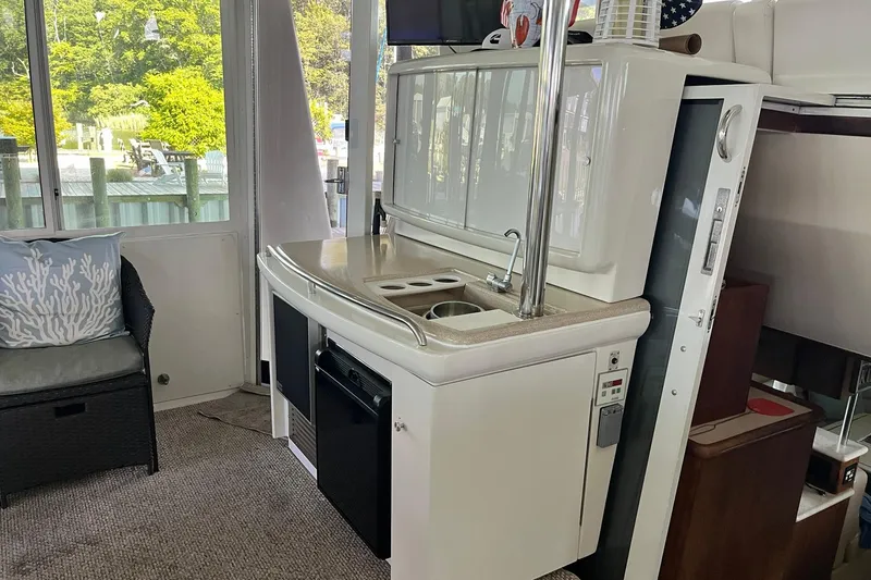Slide: The Image of Interior of 1997 Carver 500 Cockpit Motor Yacht with kitchenette and seating area. - 9