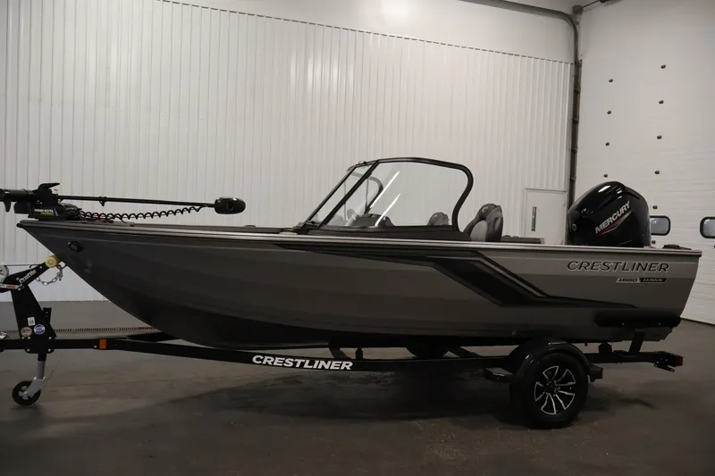Slide: The Image of 2026 Crestliner 1650 Hawk WT fishing boat in a showroom, side view. - 16