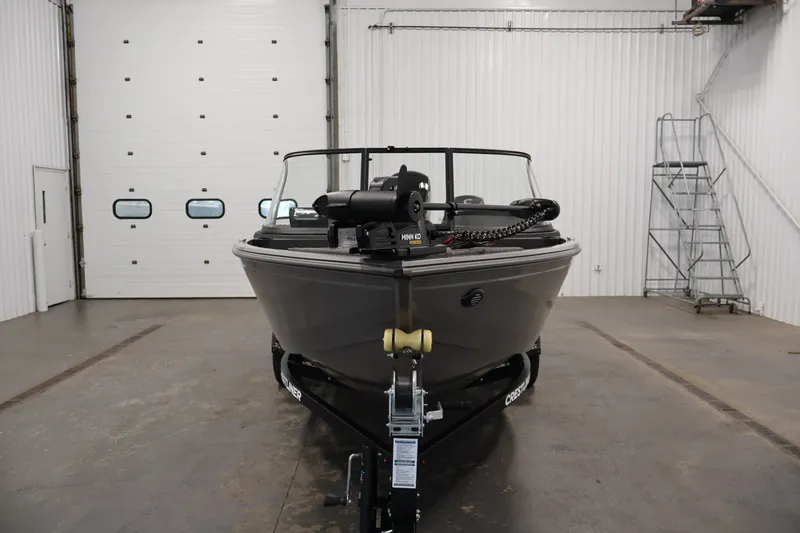 Slide: The Image of 2026 Crestliner 1650 Hawk WT boat in a spacious indoor storage facility. - 10