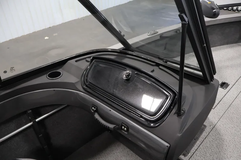 Slide: The Image of 2026 Crestliner 1650 Hawk WT boat interior with windshield and storage compartment. - 37