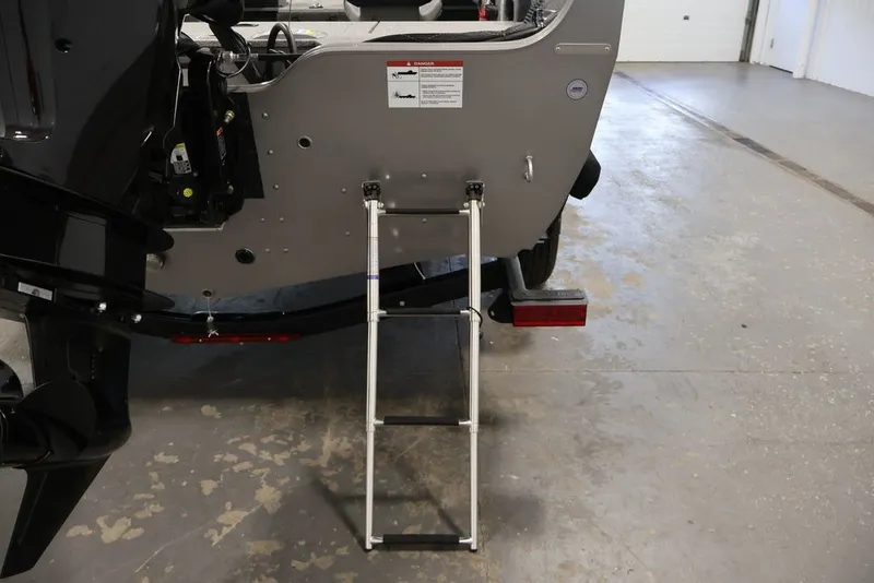 Slide: The Image of Rear view of 2026 Crestliner 1650 Hawk WT boat with ladder extended. - 39