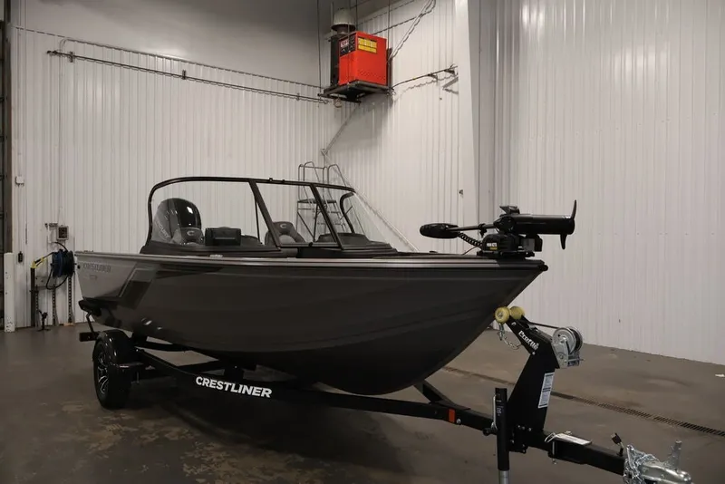 Slide: The Image of 2026 Crestliner 1650 Hawk WT boat on trailer in indoor storage facility. - 13
