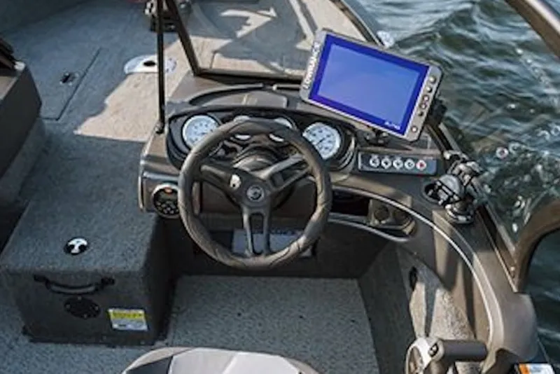 Slide: The Image of 2026 Crestliner 1650 Hawk WT boat dashboard with steering wheel and navigation display. - 52