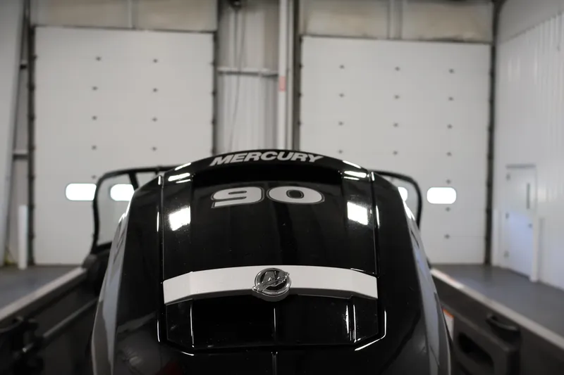 Slide: The Image of 2026 Crestliner 1650 Hawk WT with Mercury 90 engine in a garage setting. - 46